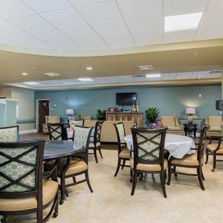 A spacious dining area with multiple tables and chairs, designed for gatherings.