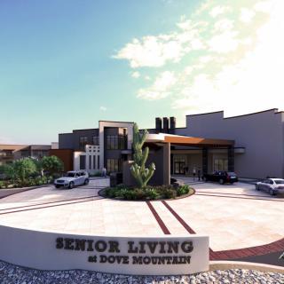 Entrance of a modern senior living facility with landscaped surroundings.