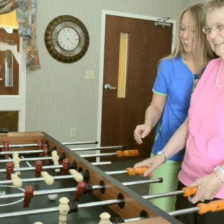 Two people playing foosball indoors.