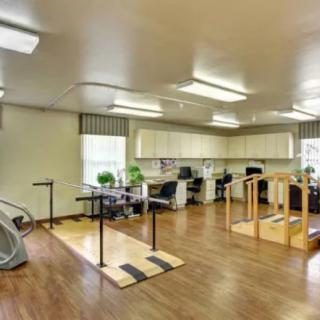 A rehabilitation and therapy room equipped with various exercise and physical therapy equipment.