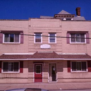 A vintage-style building with a distinct facade and large windows, located in an urban setting.