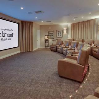 A luxurious home theater with leather seating and a large projector screen.