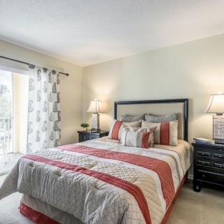 A cozy bedroom with a neatly made bed and stylish decor.