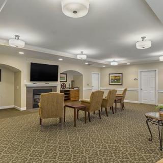 An inviting living area with arranged seating, a large television, and soft lighting.
