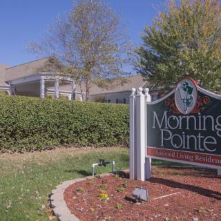 A facility sign reading 'Morning Pointe' surrounded by trees and bushes.
