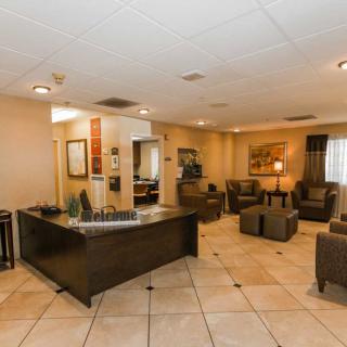 A spacious hotel lobby with a reception desk and comfortable seating.