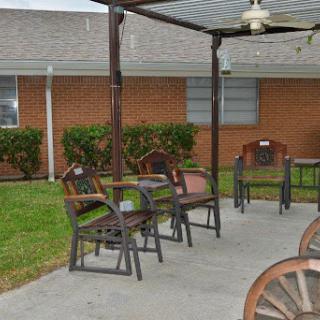 A cozy outdoor seating area with chairs and a table, perfect for relaxing in the backyard.