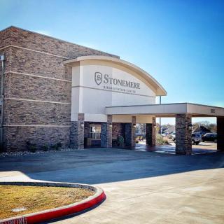 A commercial building with a prominent entrance under a clear blue sky.