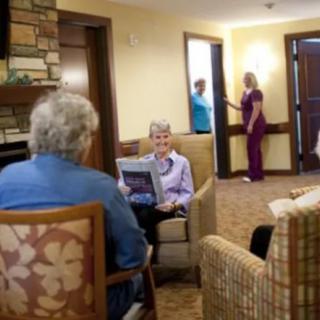Elderly individuals relaxing in a cozy nursing home setting, with some reading and others interacting.
