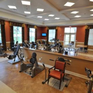 A well-equipped gym with various exercise machines and a spacious layout.