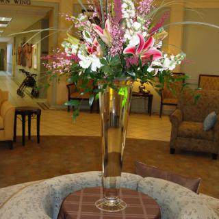 A beautiful floral arrangement in a tall vase, enhancing the elegance of the lobby.