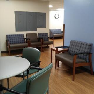 A view of a waiting room with seating and a small table.