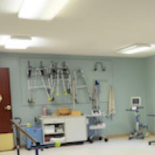 A well-equipped medical treatment room, featuring various therapy tools and a clean, organized environment.