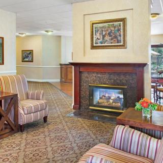 A cozy lobby with a fireplace, comfortable seating, and elegant decor.