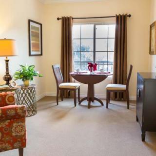 Cozy living room with a small dining area near the window.