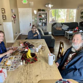 A casual gathering around the dining table, where family members engage in conversation.
