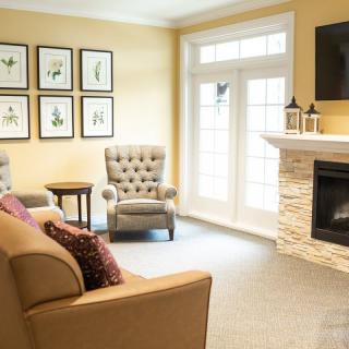 A cozy living room with comfortable seating and a modern fireplace.