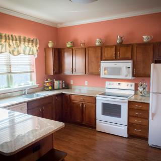 A cozy kitchen with wooden cabinets and modern appliances.