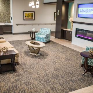A modern living room with stylish furniture and a cozy fireplace.