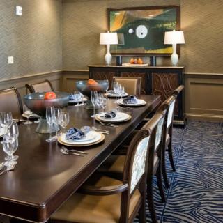 An elegantly set dining room with sophisticated decor and artwork.