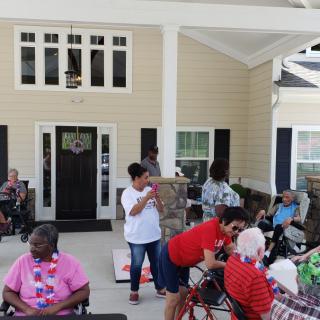 A community gathering with elderly individuals celebrating outdoors.