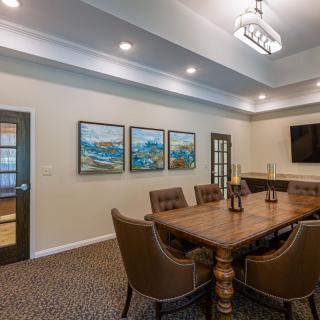 A modern dining room with elegant furniture and wall art.