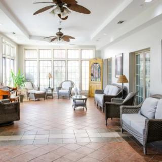 A spacious living room with abundant natural light, featuring comfortable seating and elegant decor.