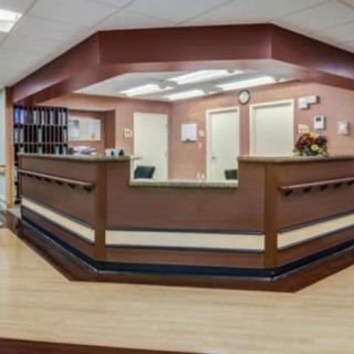 A view of a modern reception area with a central desk and office decor.