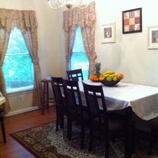 A cozy dining room with a set table and decorative elements.