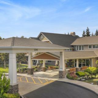 A modern building with a welcoming entrance and landscaped surroundings.