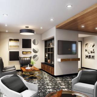 A modern living room featuring stylish furniture, contemporary artwork, and a sleek television setup.