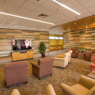 A modern lounge area with comfortable seating and a television.
