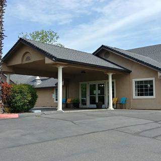 An entrance of a residential-style building with a covered driveway.