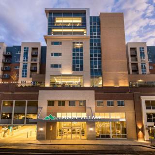 A modern building illuminated at night with glowing lights.
