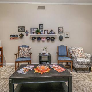 A cozy living room with decorated walls and comfortable seating.