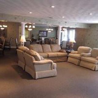 A spacious living room with comfortable seating and warm lighting.
