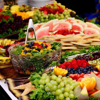 A colorful assortment of fruits arranged on a buffet table.