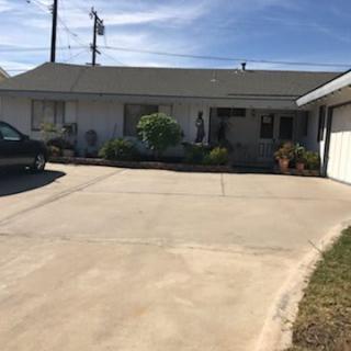 A suburban house with a wide driveway and attached garage.