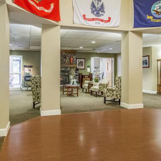A lobby area with comfortable seating and decorative flags displayed.