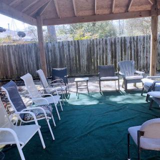 A spacious outdoor seating area under a canopy, perfect for relaxation and gatherings.