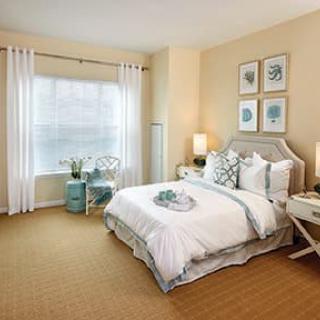 A cozy and elegantly designed bedroom with neutral tones and stylish decor.