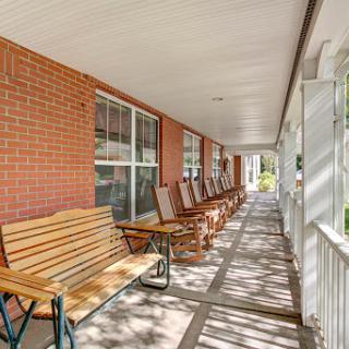 A serene porch area featuring rocking chairs, perfect for relaxation.