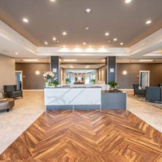 A modern hotel lobby with stylish lighting and elegant flooring.
