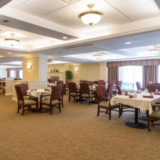 A spacious and elegantly decorated dining area with multiple tables and chairs, ready to welcome guests.