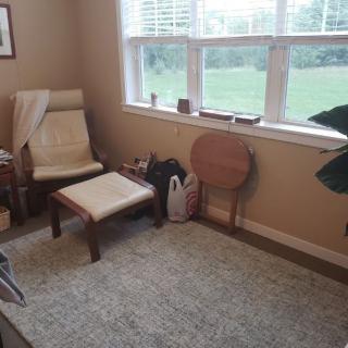 A cozy living room corner with a chair by the window.