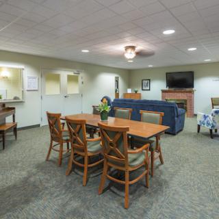 A cozy lounge and dining area featuring wooden furniture and a comfortable sofa.