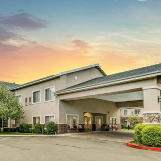 A hotel building at sunset with a welcoming entrance.