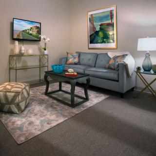 A cozy living room featuring a comfortable sofa, coffee table, and stylish decor.