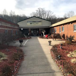 A welcoming entrance to a community center surrounded by well-maintained landscaping.