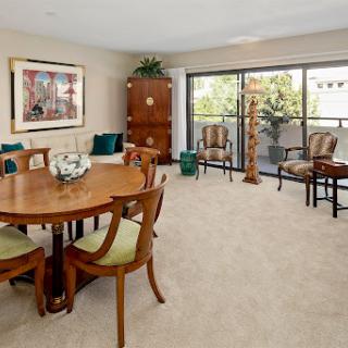 A cozy living and dining area showcasing elegant furniture and warm decor.